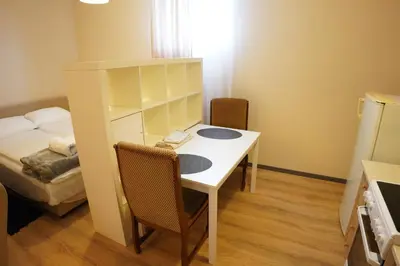 a small room with a desk and a bed at Apartmani Kula Novi Banovci Svetosavska 137 in Belgrade