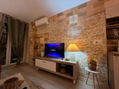 a living room with a tv on a wooden table at Apartman A 24 in Belgrade