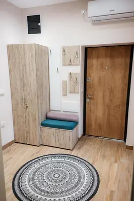 a room with two wooden doors and a rug at Tomin sokak Apartment in Belgrade