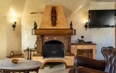 a living room with a fireplace and a tv at Royal Casa in Belgrade