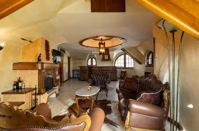 a living room with leather furniture and a ceiling at Royal Casa in Belgrade