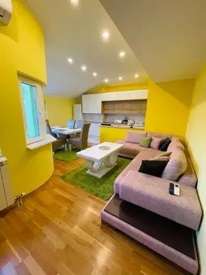 a living room with a purple couch and yellow walls at Zemun Belgrade Apartment in Belgrade