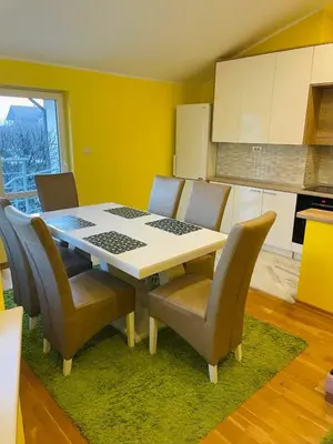 a kitchen with a dining room table and chairs at Zemun Belgrade Apartment in Belgrade