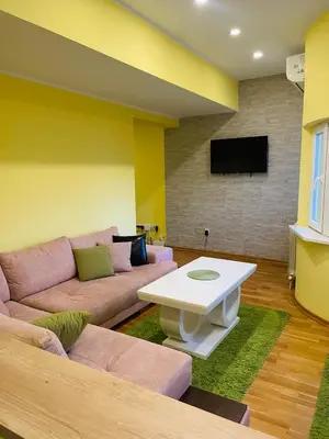 a living room with a couch and a table at Zemun Belgrade Apartment in Belgrade