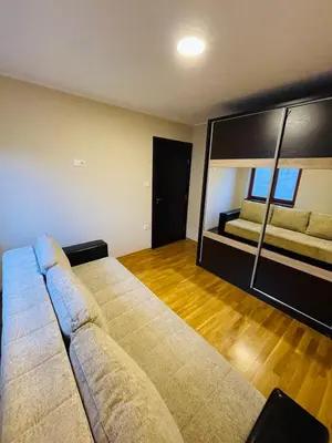 a living room with a couch and a large mirror at Zemun Belgrade Apartment in Belgrade