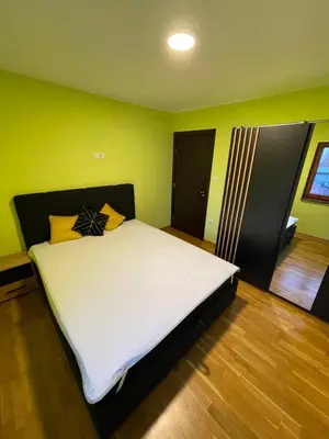 a bedroom with a bed in a room with green walls at Zemun Belgrade Apartment in Belgrade