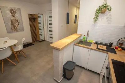 a kitchen with a counter and a table and a sink at The Old Courtyard in Belgrade