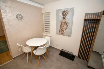 a dining room with a white table and chairs at The Old Courtyard in Belgrade