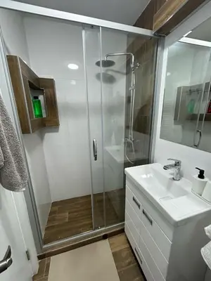 a bathroom with a shower and a sink at The Old Courtyard in Belgrade