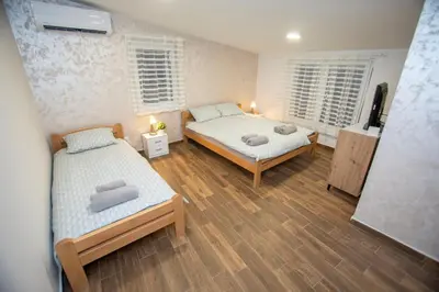 a room with two beds and two windows at The Old Courtyard in Belgrade