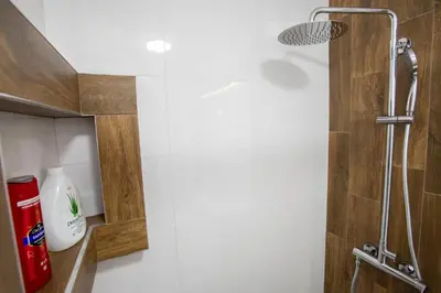 a bathroom with a shower with a shower head at The Old Courtyard in Belgrade