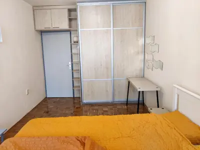 a bedroom with a bed and a sliding glass door at Danube Riverview in Belgrade