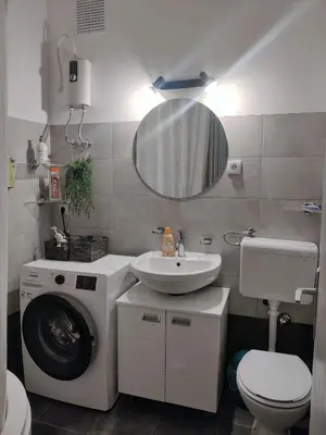 a bathroom with a washing machine and a sink at Danube Riverview in Belgrade