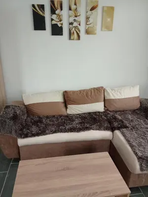 a couch with pillows on it in a room at Stan na dan Platičevo in Platičevo