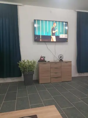 a flat screen tv on a wall in a living room at Stan na dan Platičevo in Platičevo