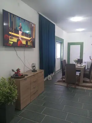 a living room with a desk and a table at Stan na dan Platičevo in Platičevo