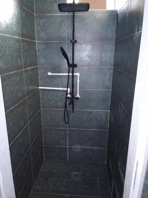 a shower with a shower head in a bathroom at Stan na dan Platičevo in Platičevo