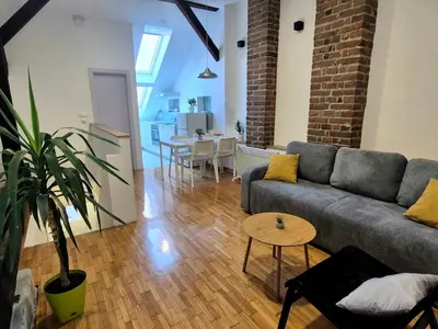 a living room with a couch and a table at Roof in Belgrade