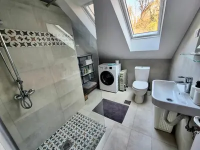 a bathroom with a shower and a toilet and a sink at Roof in Belgrade