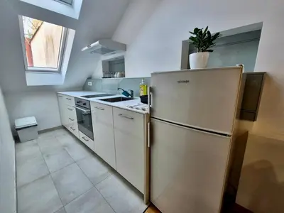 a kitchen with a stainless steel refrigerator and a sink at Roof in Belgrade