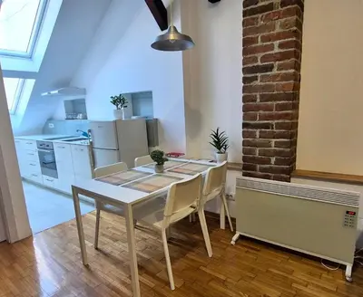 a dining room table and chairs in a kitchen at Roof in Belgrade