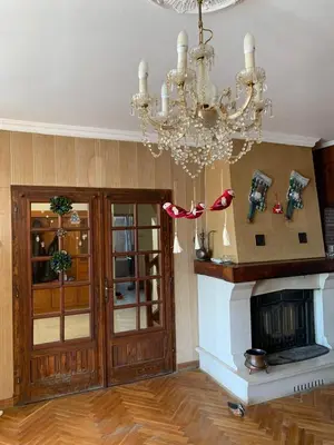 a living room with a chandelier and a fireplace at Kosmaj Residence in Dučina