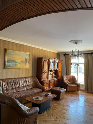 a living room with leather couches and a table at Kosmaj Residence in Dučina
