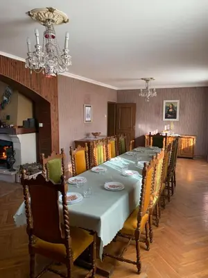 a dining room with a long table and chairs at Kosmaj Residence in Dučina