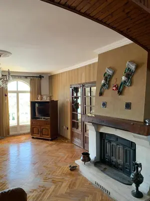 a living room with a fireplace and a television at Kosmaj Residence in Dučina