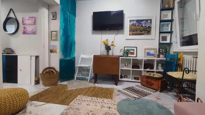 a living room with a tv on a wall at CoCo Studio Bright & Stylish Apartment in Central Belgrade in Belgrade