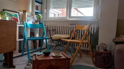 two chairs and a table in a living room at CoCo Studio Bright & Stylish Apartment in Central Belgrade in Belgrade