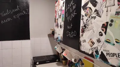 a kitchen with a counter with writing on the wall at CoCo Studio Bright & Stylish Apartment in Central Belgrade in Belgrade