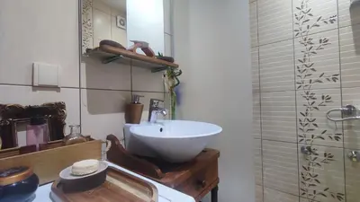 a bathroom with a white sink and a shower at CoCo Studio Bright & Stylish Apartment in Central Belgrade in Belgrade