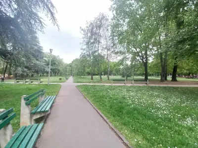 a path in a park with benches and trees at Apartman Gala Beograd in Belgrade