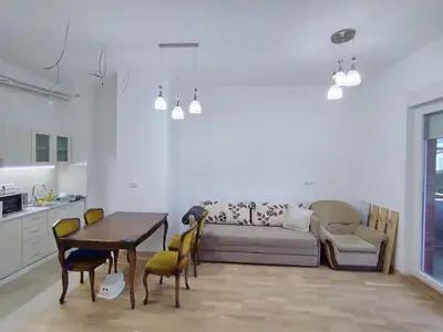 a living room with a couch and a table and chairs at Apartman Gala Beograd in Belgrade