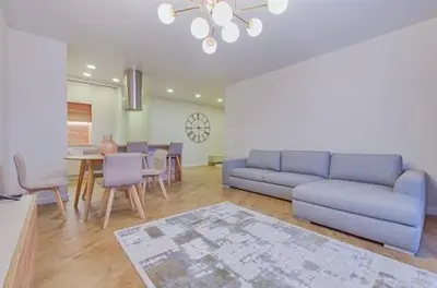 a living room with a blue couch and a table at Günlük daire in Belgrade