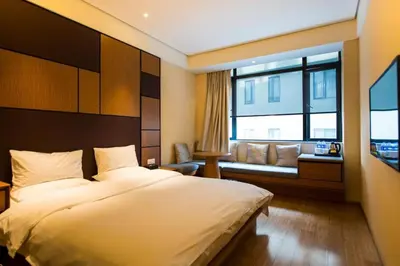 a bedroom with a bed and a couch and a window at Günlük daire in Belgrade