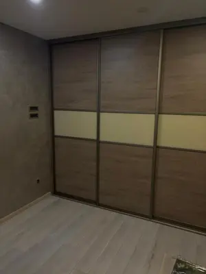 a room with two garage doors and wooden floors at Luxurious apartment with a jaccuzi and 4 bedrooms in Belgrade