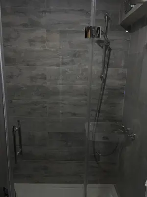 a shower with a glass door in a bathroom at Luxurious apartment with a jaccuzi and 4 bedrooms in Belgrade