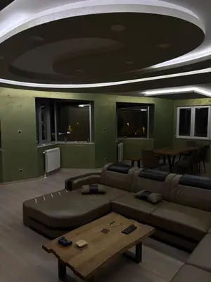 a living room with a couch and a table at Luxurious apartment with a jaccuzi and 4 bedrooms in Belgrade