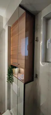 a glass cabinet in a bathroom with a plant at EMEM luxury apartment in Belgrade