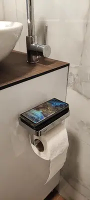 a cell phone on a toilet paper roll in a bathroom at EMEM luxury apartment in Belgrade