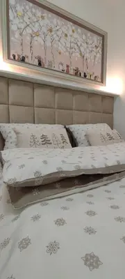 a bed with two pillows and a picture on the wall at EMEM luxury apartment in Belgrade