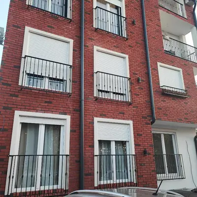 a red brick building with windows and balconies at EMEM luxury apartment in Belgrade