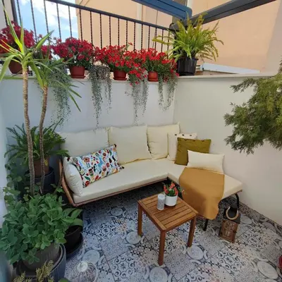 a patio with a couch and a table and potted plants at EMEM luxury apartment in Belgrade