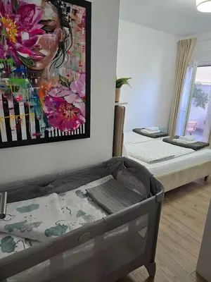 a room with a bed and a painting on the wall at EMEM luxury apartment in Belgrade