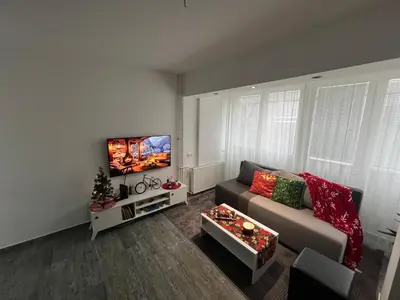 a living room with a couch and a flat screen tv at Apartman Jevtic in Obrenovac