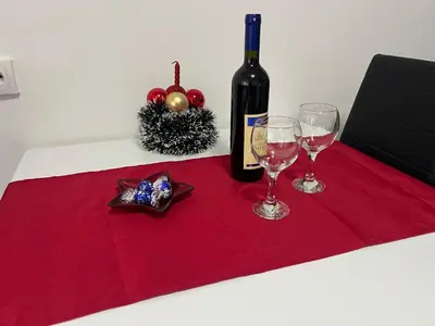 a bottle of wine and two glasses on a table at Apartman Jevtic in Obrenovac