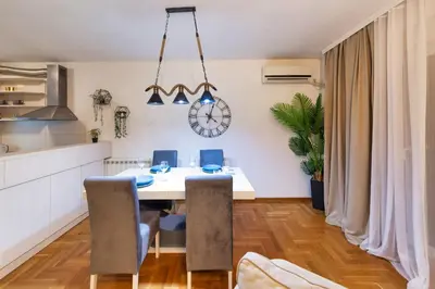 a kitchen and dining room with a table and chairs at Apartment SIX - free parking in Belgrade