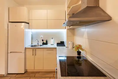 a small kitchen with a sink and a refrigerator at Apartment SIX - free parking in Belgrade